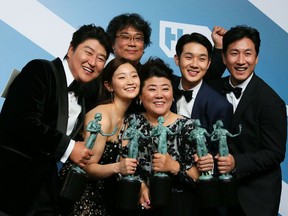 'Parasite' cast (left to right): Song Kang-ho, Cho Yeo-jeong, director Bong Joon-ho, Lee Jung-eun, Choi Woo-shik, and Lee Sun-kyun pose with the trophy for Outstanding Performance by a Cast in a Motion Picture in the press room during the 26th Annual Screen Actors Guild Awards at the Shrine Auditorium in Los Angeles on Jan. 19, 2020.