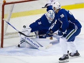 Justin Bailey of the Utica Comets, who attended the Canucks' training camp in Victoria last September, is stopped by camp goalie Zane McIntyre at the Save-On-Foods Arena.