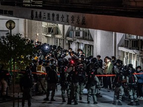 Riot police detain a mass amount of residents in Fanling district on January 26, 2020 in Hong Kong, China. Protesters clash over a proposal of using newly constructed housing as quarantine site in a residential area.