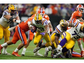 Jan 13, 2020; New Orleans, Louisiana, USA; LSU Tigers running back Clyde Edwards-Helaire (22) runs the ball against the Clemson Tigers in the fourth quarter in the College Football Playoff national championship game at Mercedes-Benz Superdome.