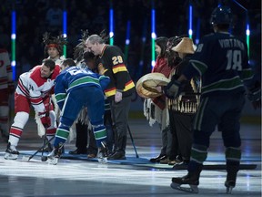 Former Vancouver enforcer Gino Odjick drops the ceremonial puck before the Canucks played the Carolina Hurricanes at Rogers Arena on Jan. 23, 2019.