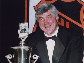 Vancouver Canucks' Pat Quinn holds the Jack Adams Award for coach of the year at the NHL Awards ceremony in Toronto, Ont., on June 17, 1992.