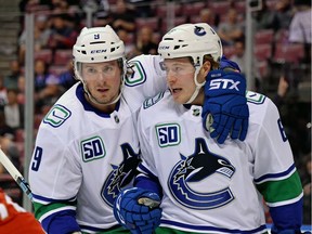 Canucks' winger Brock Boeser, right, celebrates with Vancouver teammate J.T. Miller (left) after scoring a goal against the Florida Panthers on Thursday at the BB&T Center. The Canucks lost 5-2.