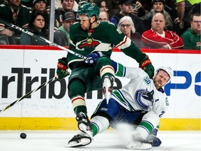Minnesota Wild forward Jordan Greenway hits Vancouver Canucks defenceman Alexander Edler during the first period at Xcel Energy Center.