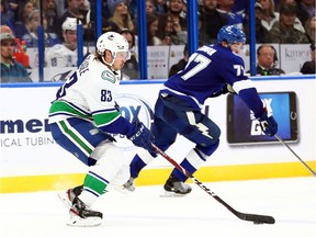 Vancouver Canucks' centre Jay Beagle skates with the puck as Tampa Bay Lightning defenceman Victor Hedman defends during Tuesday's action at Amalie Arena in Florida.