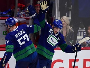 Vancouver Canucks defenceman Tyler Myers celebrates with captain Bo Horvat after defeating the San Jose Sharks at Rogers Arena on Jan. 18.