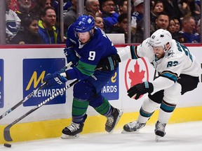 Jan 18, 2020; Vancouver, British Columbia, CAN;  San Jose Sharks forward Barclay Goodrow (23) reaches for the puck against Vancouver Canucks forward J.T. Miller (9) during the first period at Rogers Arena. Mandatory Credit: Anne-Marie Sorvin-USA TODAY Sports