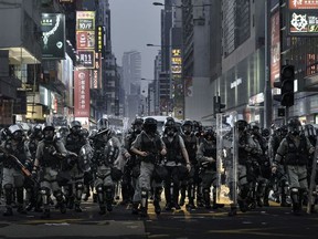 Rémy Soubanère photo of police in Hong Kong on October 1st, 2019, the 70th anniversary of the People's Republic of China. It was declared "grief day" by protesters. The photo is part of an exhibition called Revolution of Our Times at the Polygon Gallery.