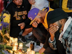Mourners gather in Microsoft Square near the Staples Center to pay respects to Kobe Bryant after a helicopter crash killed the retired basketball star, in Los Angeles, California, U.S., January 26, 2020.
