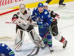 Bo Horvat skates in front of Arizona Coyotes goalie Adin Hall and Ilya Lyubushkin duing NHL action at Rogers Arena in Vancouver on Thursday.