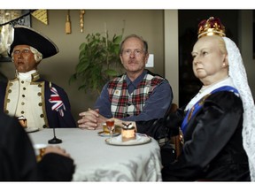 Ken Lane, the former owner of the Royal London Wax Museum, poses with Queen Victoria and Capt. Cook.