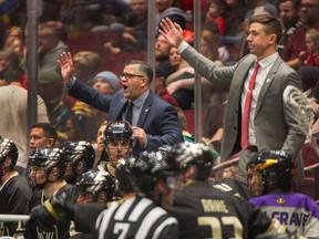 Vancouver Warriors coach Chris Gill, centre, and assistant coach Clayton Richardson, right, couldn't guide the club to a third straight win on Friday.