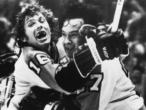 Reggie Leach (right) and Flyers teammate Bobby Clarke celebrate Leach’s OT winner in a 1976 playoff game versus Boston. (AP FILES)