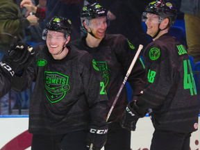 Olli Juolevi (right) celebrates with his Utica teammates after Brogan Rafferty (left) scored a goal in early January.