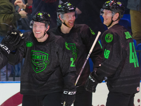 Olli Juolevi (right) celebrates with his Utica teammates after Brogan Rafferty (left) scored a goal on Wednesday.