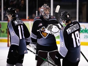 Brothers Cole and Jackson Shepard celebrate with goaltender Trent Miner during the Vancouver Giants' 6-2 win on Saturday in Victoria.