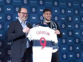 Whitecaps sporting director Axel Schuster, left, welcomes the Major League Soccer team's newest signing, Canadian striker Lucas Cavallini to Vancouver during a press conference on Dec. 16, 2019 at B.C. Place Stadium.