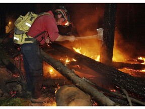 Forest Service fire fighters work in the pitch black night putting out hot spots.
