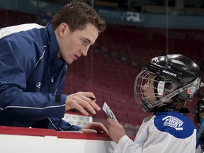 Then-Vancouver Canuck Rick Rypien talks to a youngster involved in the Canucks First Strides program. Rypien died at age 27 in August 2011.