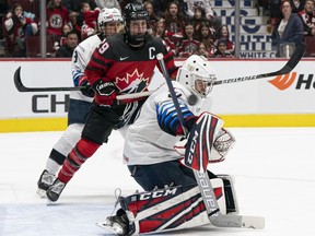 Marie-Philip Poulin #29 of Canada looks on as a shot  goes over the shoulder of goalie Aerin Frankel #31 of the United States for a goal during game four of the 2020 Rivalry Series at Rogers Arena on February 5, 2020 in Vancouver, Canada.