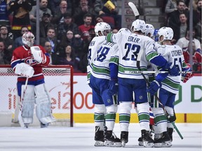 Alex Edler celebrates his goal with teammates during the second period against the Montreal Canadiens at the Bell Centre.