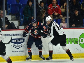 Eric Florchuk of the Vancouver Giants, right, battles along the boards with Ryan Hughes of the Kamloops Blazers at the Langley Events Centre recently. Florchuk and Hughes were teammates previously with the Saskatoon Blades.