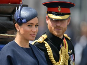 (FILES) In this file photo taken on June 08, 2019 Britain's Meghan, Duchess of Sussex (L) and Britain's Prince Harry, Duke of Sussex (R) return to Buckingham Palace after the Queen's Birthday Parade, 'Trooping the Colour', in London.
