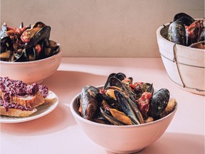 Rustic olive toasts complement Chef Ned Bell's simple stew of mussels, caramelized onions and cherry tomatoes.