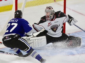 Vancouver Giants netminder David Tendeck stops Victoria Royals winger Phillip Schultz during a January WHL game at the Langley Events Centre.
