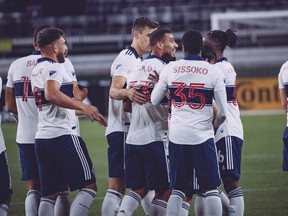 The Vancouver Whitecaps mob left back Ali Adnan after his 25-yard free kick golazo against the New England Revolution at the Rose City Invitational in Portland on Wednesday.