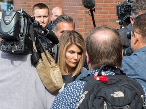 Actress Lori Loughlin (C) and husband Mossimo Giannulli (C rear) exit the Boston Federal Court house after a pre-trial hearing with Magistrate Judge Kelley at the John Joseph Moakley US Courthouse in Boston on August 27, 2019.