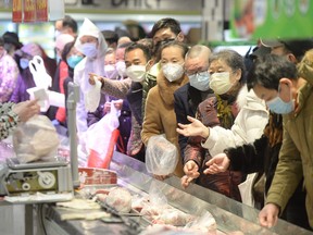 People wearing protective masks shop at a supermarket in Wuhan, the epicentre of the outbreak of a novel coronavirus, in China's central Hubei province.