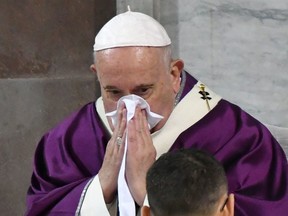 Pope Francis blows the nose as he leads the Ash Wednesday mass which opens Lent, the forty-day period of abstinence and deprivation for Christians before Holy Week and Easter, on Feb. 26, 2020, at the Santa Sabina church in Rome.