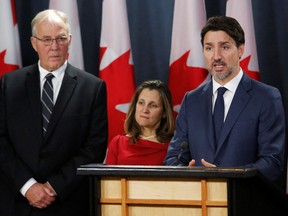 Prime Minister Justin Trudeau speaks to reporters about the Coastal GasLink pipeline crisis and blockades along with Minister of Public Safety and Emergency Preparedness Bill Blair, and Deputy Prime Minister Chrystia Freeland in Ottawa on Friday.
