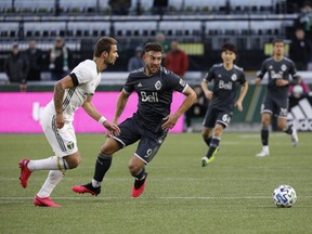 Whitecaps striker Lucas Cavallini pressures the Portland Timbers back line during their Rose City Invitational preseason tournament game on Sunday. Cavallini scored in the game, but the Timbers won 2-1.