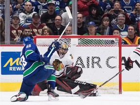 Bo Horvat scores against Chicago Blackhawks goalie Corey Crawford during the first period.