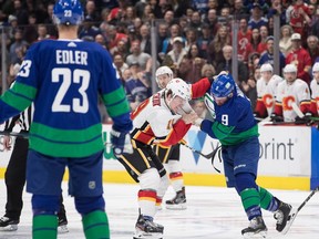 Calgary Flames' Matthew Tkachuk (19) and Vancouver Canucks' J.T. Miller (9) fight during the first period of an NHL hockey game in Vancouver, on Saturday February 8, 2020.
