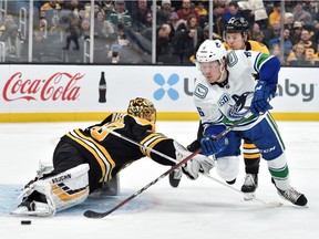 Boston Bruins goaltender Tuukka Rask (40) makes a save on Vancouver Canucks right wing Brock Boeser (6) during the second period at TD Garden.