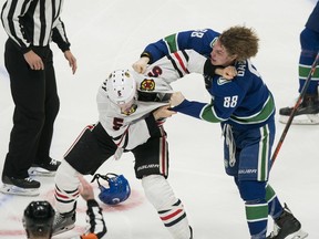 Chicago Blackhawks defenseman Connor Murphy fights with Vancouver Canucks forward Adam Gaudette in the third period Wednesday at Rogers Arena.