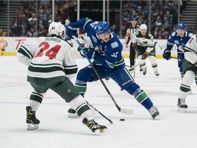 Minnesota Wild defenceman Matt Dumba tries to stop Bo Horvat of the Vancouver Canucks during an NHL game at Rogers Arena in February.
