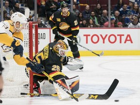 Vancouver Canucks goalie Jacob Markstrom (25) makes a save on Nashville Predators forward Nick Bonino (13) during the second period  in a game at Rogers Arena.