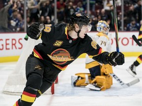 Adam Gaudette looks great celebrating a goal wearing the throwback jerseys from the 1990s featuring the skate.