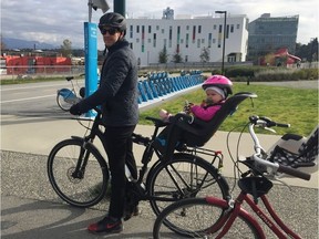 Keane Gruending and his little girl with the Cube Hybrid One electric bike that was stolen despite being double-locked inside the bike locker at his apartment building.
