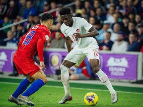 Alphonso Davies takes on the U.S.'s Sergiño Dest during a Nations League match last November in Orlando, Fla. Davies and the Canadian men's team will play their first game in Victoria since 1993 when they host Trinidad and Tobago at Westhills Stadium in Langford.