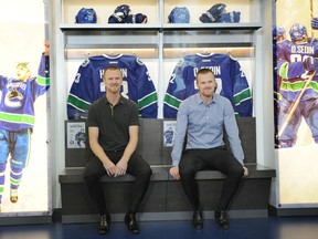 Henrik, left, and Daniel Sedin appear at a media event to mark the 50th season of the Canucks, at Rogers Arena in Vancouver on Feb. 10.