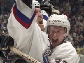 Trent Klatt and Henrik Sedin celebrate a Canucks goal during first period NHL playoff action at GM Place on April 16, 2001.