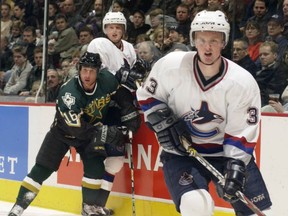 Trent Klatt and Herik Sedin celebrate the first Vancouver Canucks' goal during NHL playoff action at GM Place on April 16, 2001.