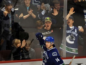 Canucks winger Alex Burrows and fans celebrate his goal against the visiting St. Louis Blues on March 19, 2009.