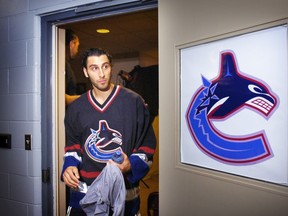 Goalie Roberto Luongo wears his brand new Canucks jersey as he leaves the team's photo sessions on Sept. 14, 2006. The star netminder had been acquired three months earlier on NHL draft weekend by general manager Dave Nonis.