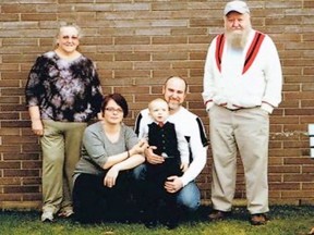 2014 photo from the Facebook shows Derik Lord (kneeling) with his parents, his partner who is identified on the Facebook site as Jasminda Hanbury, and his young son.
